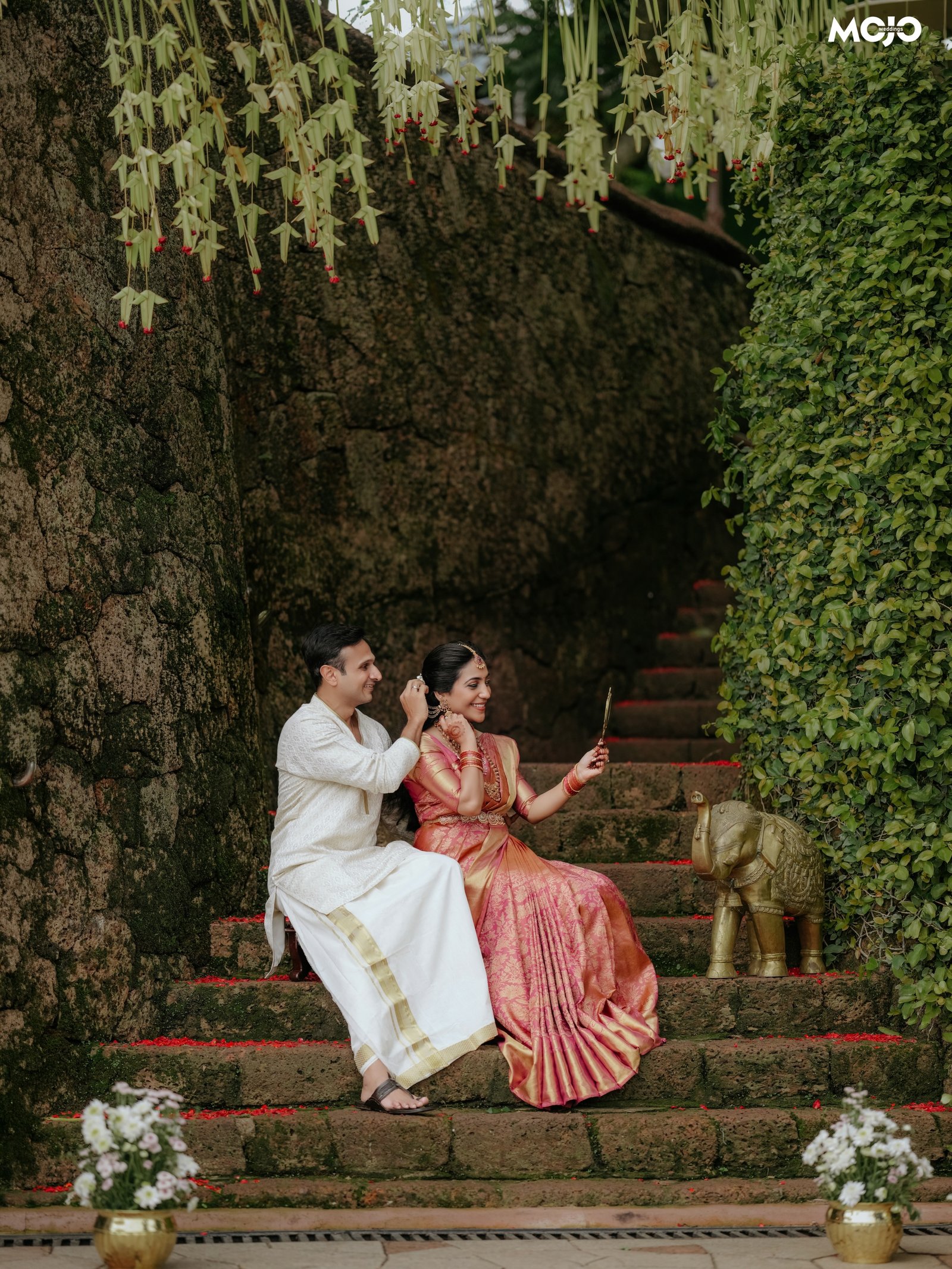 A newlywed couple sharing a quiet moment on stone steps