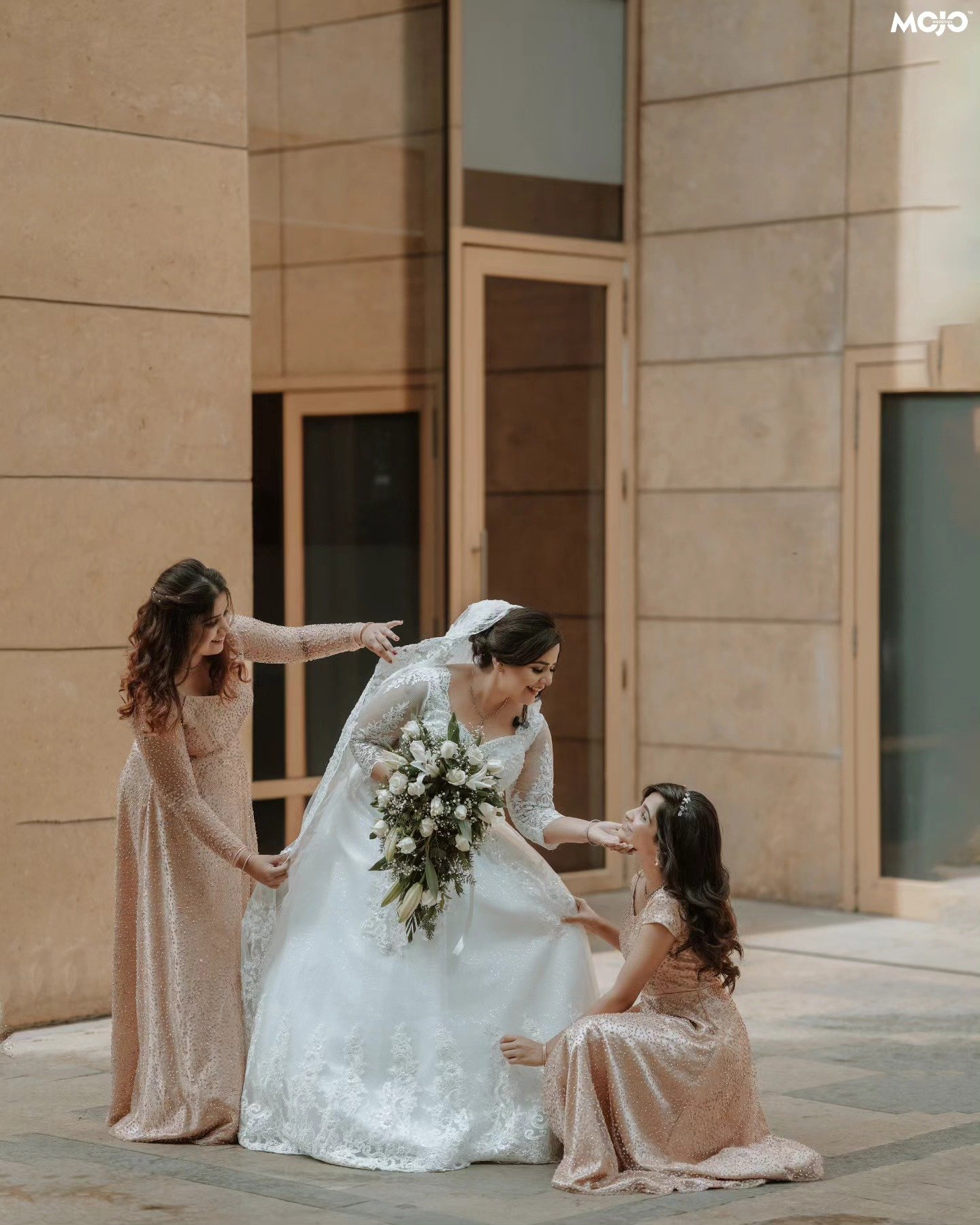 A bride sharing a playful moment with her bridesmaids